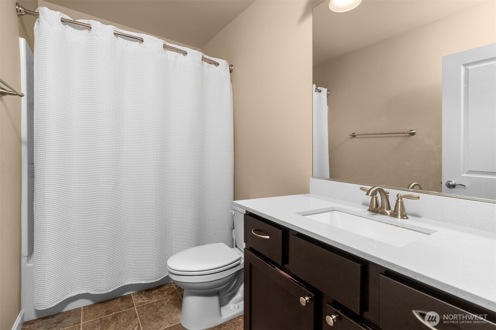 985 Riley Drive East Enumclaw, WA 98022 - Photo 26 of 33 a bathroom with a sink a toilet and shower curtain