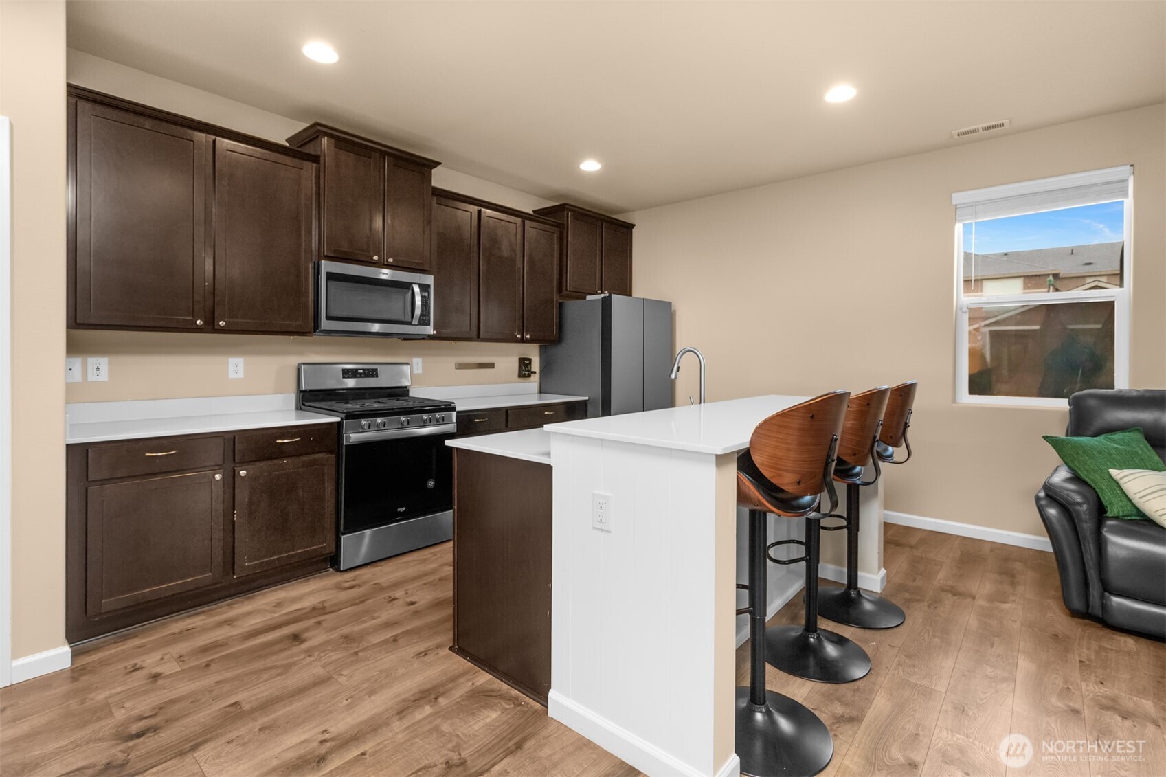 985 Riley Drive East Enumclaw, WA 98022 - Photo 6 of 33 a kitchen with kitchen island stainless steel appliances cabinets a sink and a counter top space
