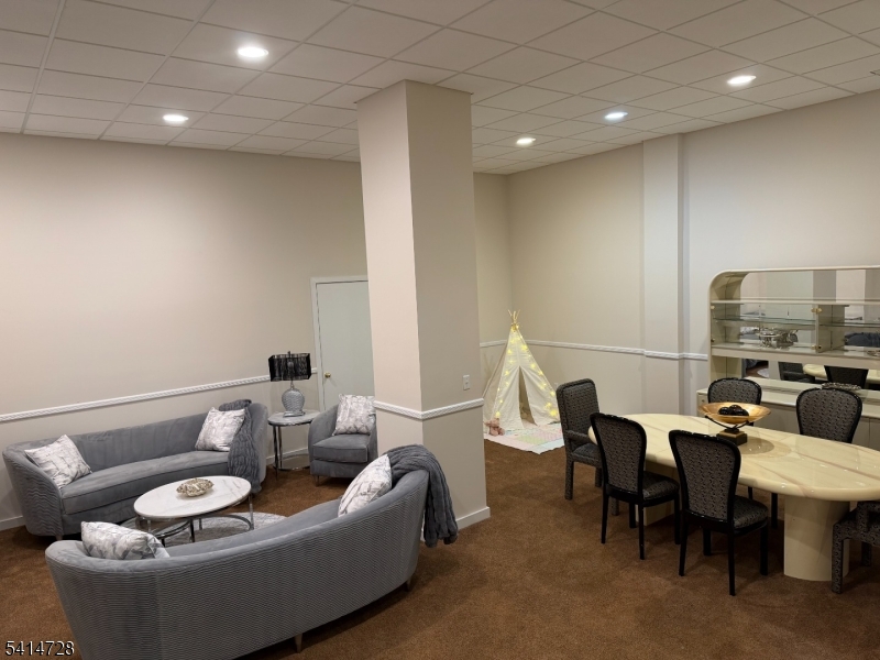 8 Union Hill Road Denville, NJ 07834 - Photo 33 of 47 a living room with furniture and a dining table with rug