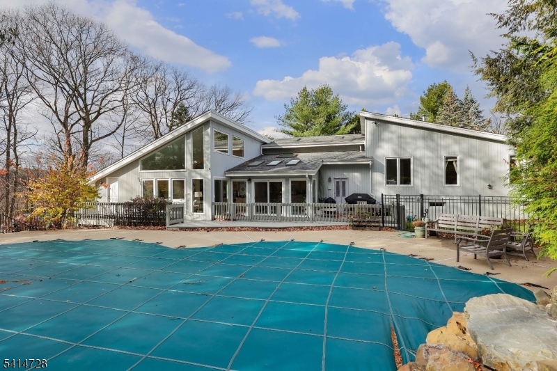 8 Union Hill Road Denville, NJ 07834 - Photo 39 of 47 a front view of a house with swimming pool having outdoor seating