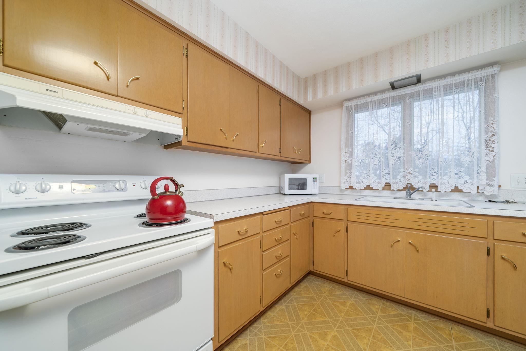 3816 Shirley Road Rockford, IL 61108 - Photo 20 of 31 a kitchen with stainless steel appliances granite countertop a sink and cabinets with wooden floor