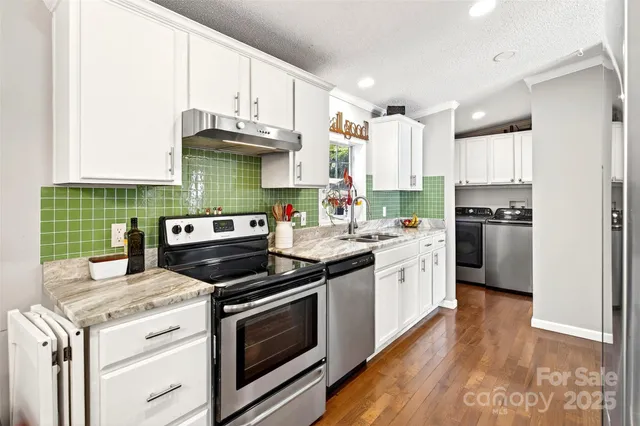 a kitchen with stainless steel appliances granite countertop a stove and a refrigerator