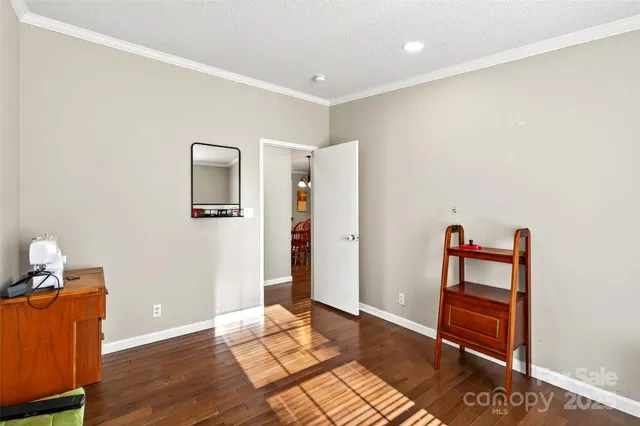 an empty room with wooden floor and closet