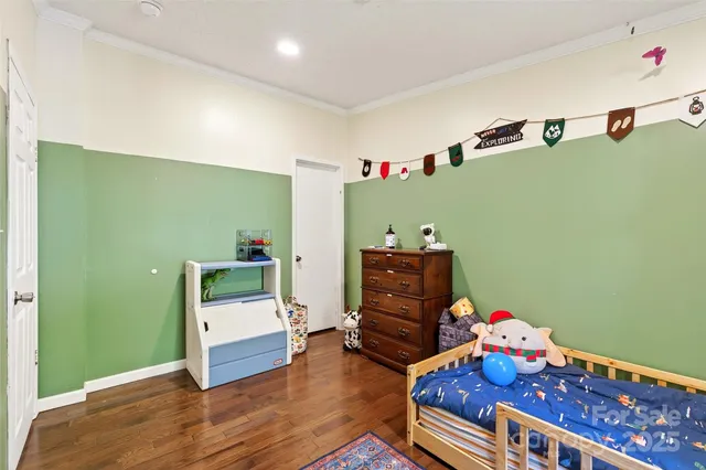 a bed room with furniture and a wooden floor