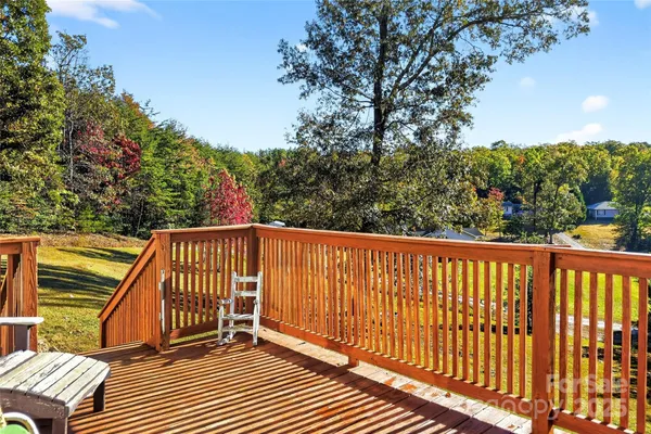 a view of balcony with wooden floor and fence