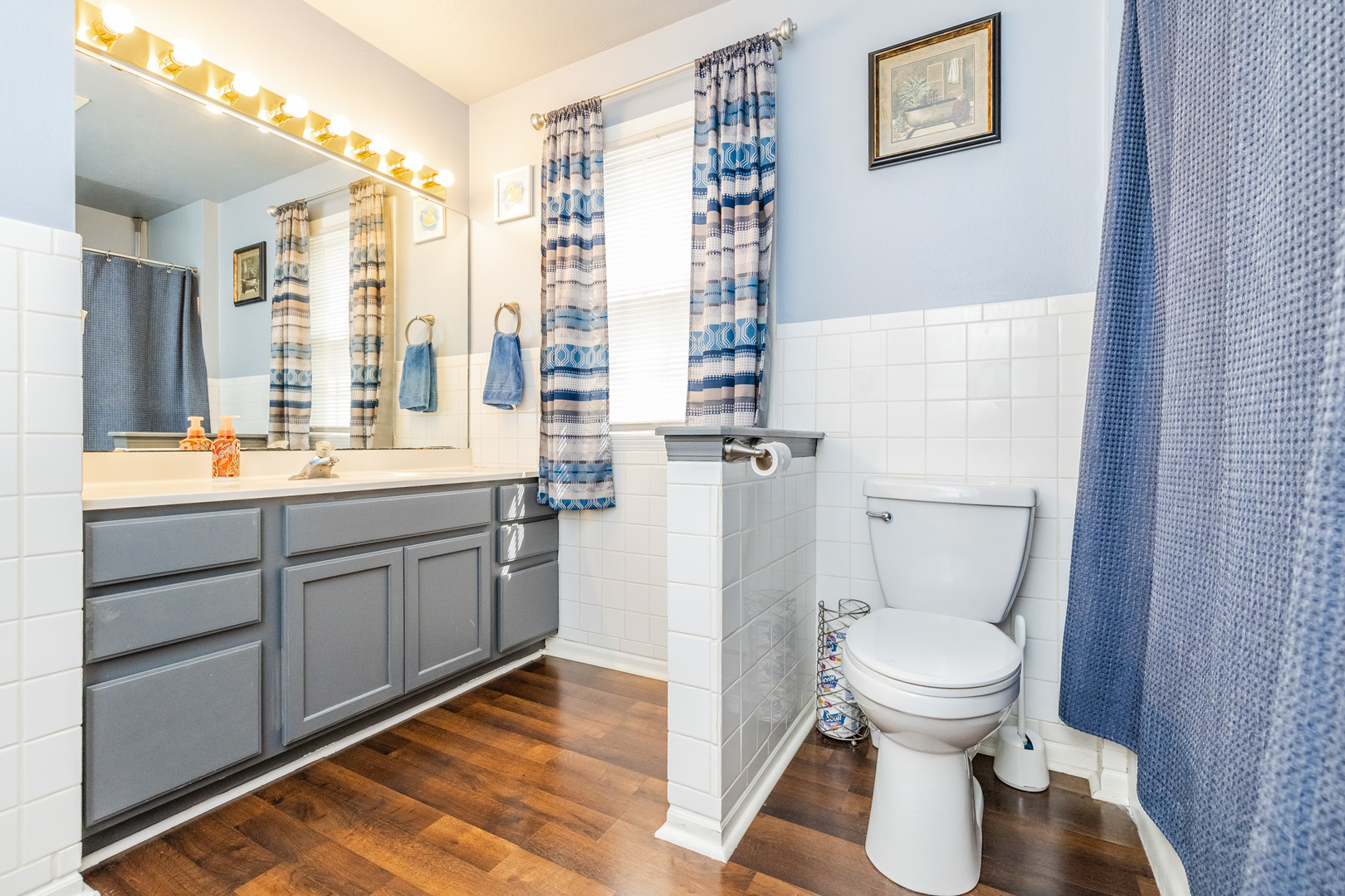 6038 Nimtz Road Loves Park, IL 61111 - Photo 18 of 26 a spacious bathroom with a toilet sink and a large mirror