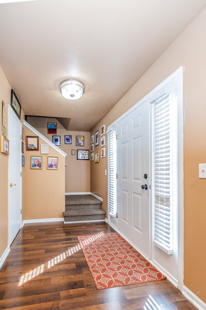 6038 Nimtz Road Loves Park, IL 61111 - Photo 5 of 26 a view of a hallway with wooden floor and windows