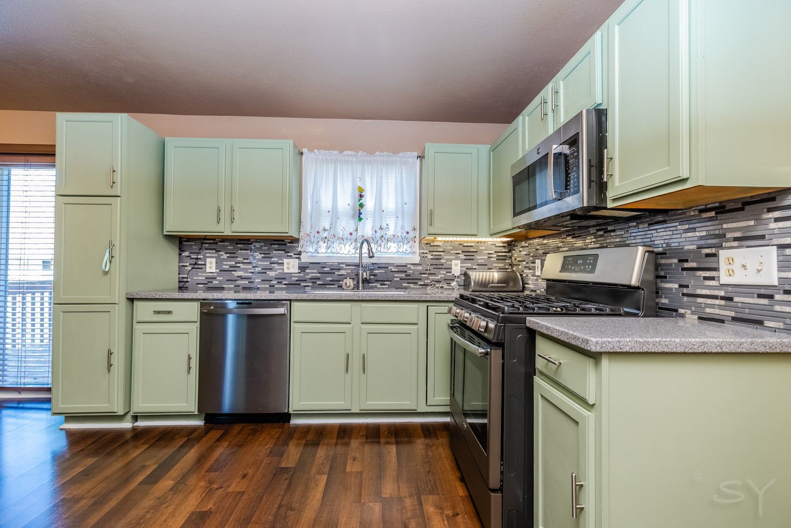 6038 Nimtz Road Loves Park, IL 61111 - Photo 6 of 26 a kitchen with stainless steel appliances granite countertop a stove a sink and a microwave