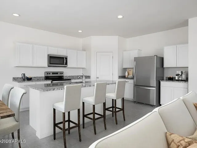 a kitchen with stainless steel appliances a refrigerator stove microwave and cabinets