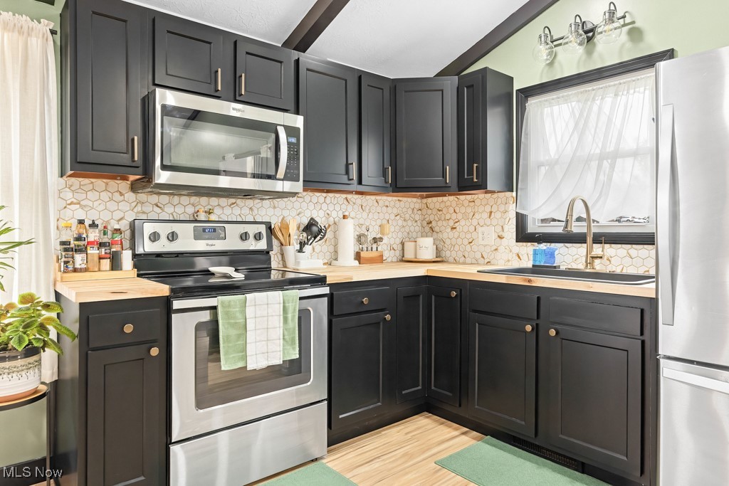 4551 17th Street Northwest Canton, OH 44708 - Photo 9 of 39 Kitchen featuring stainless steel appliances, a sink, and dark cabinets