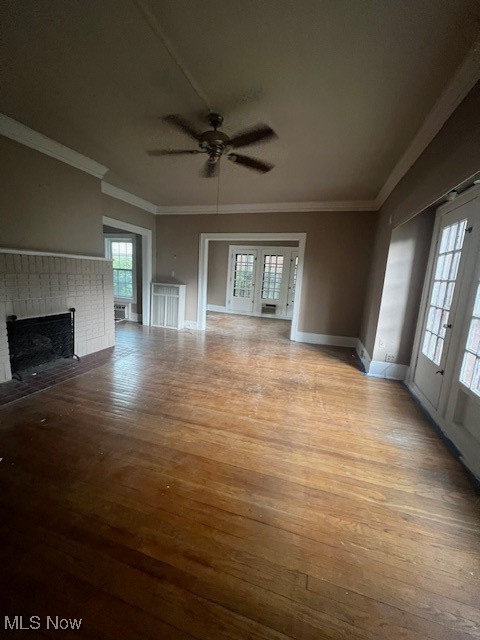 2915 Ludlow Road Cleveland, OH 44120 - Photo 36 of 50 Unfurnished living room with ornamental molding, a brick fireplace, ceiling fan, and wood-type flooring
