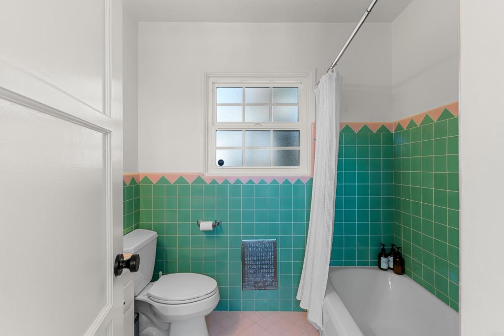 5504 Linda Rosa Avenue La Jolla, CA 92037 - Photo 14 of 24 a bathroom with a sink a toilet a shower and a window
