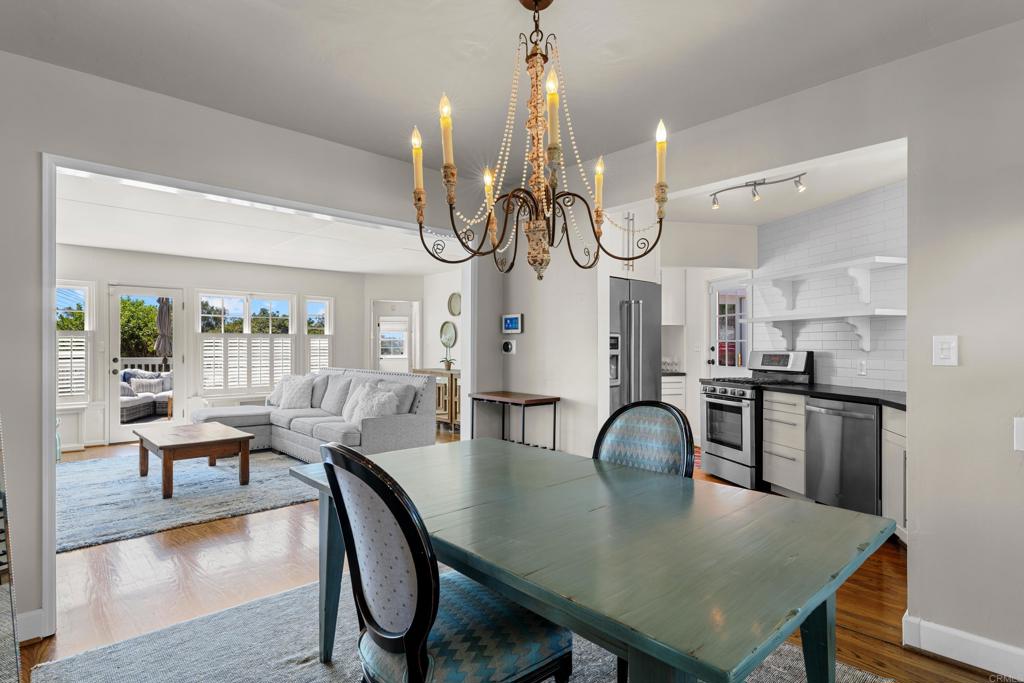 5504 Linda Rosa Avenue La Jolla, CA 92037 - Photo 5 of 24 a view of a dining room with furniture and chandelier