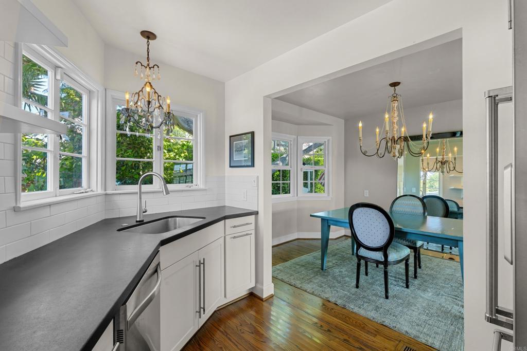 5504 Linda Rosa Avenue La Jolla, CA 92037 - Photo 10 of 24 a kitchen that has a sink and chairs in it