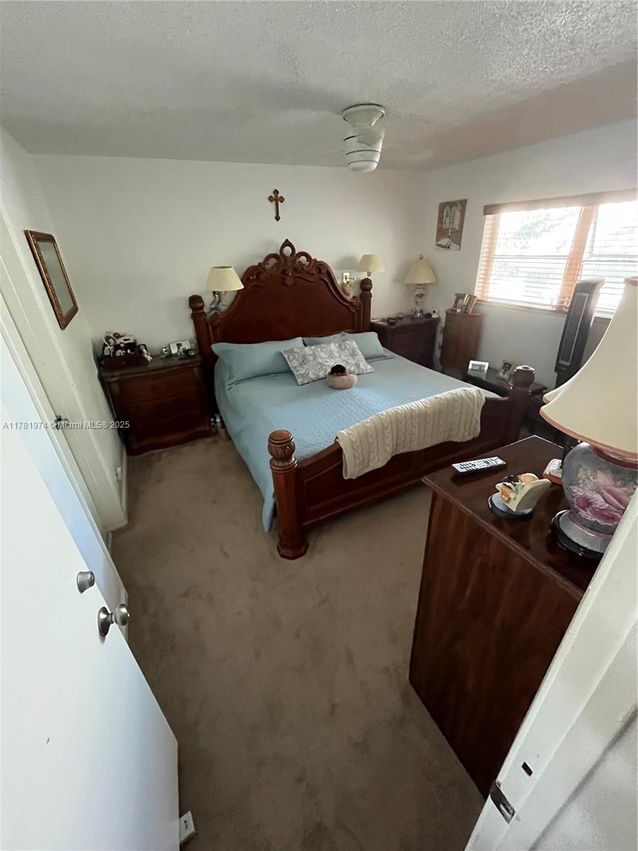 651 Pine Drive, Unit 305 Pompano Beach, FL 33060 - Photo 13 of 21 a bedroom with a bed and window