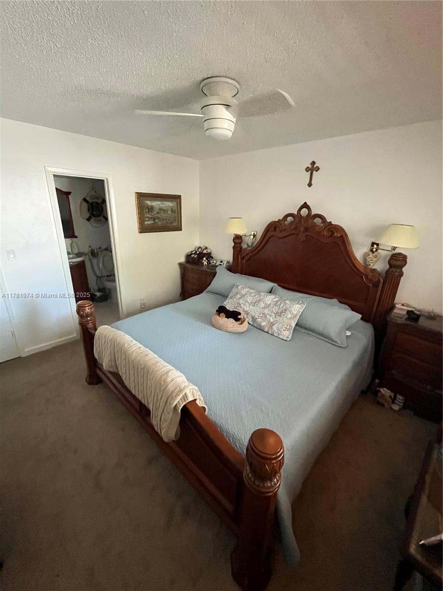 651 Pine Drive, Unit 305 Pompano Beach, FL 33060 - Photo 14 of 21 a bed sitting in a bedroom next to a window