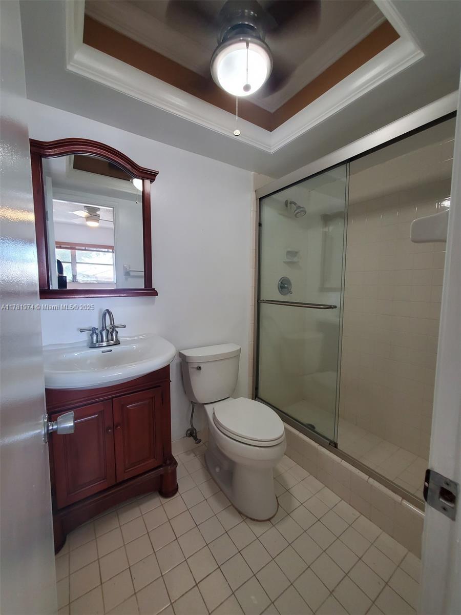 651 Pine Drive, Unit 305 Pompano Beach, FL 33060 - Photo 16 of 21 a bathroom with a toilet sink and mirror