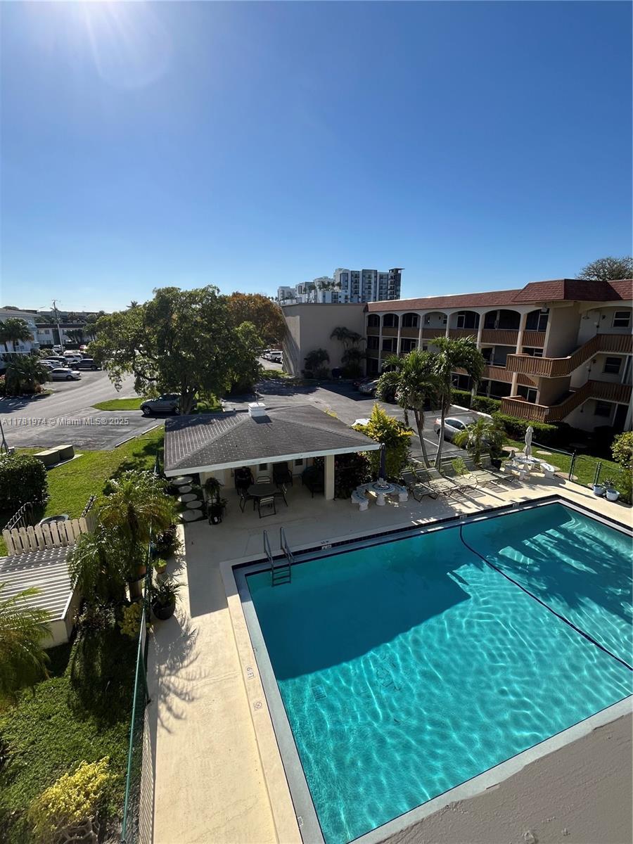 651 Pine Drive, Unit 305 Pompano Beach, FL 33060 - Photo 2 of 21 a view of a swimming pool with a patio and a yard