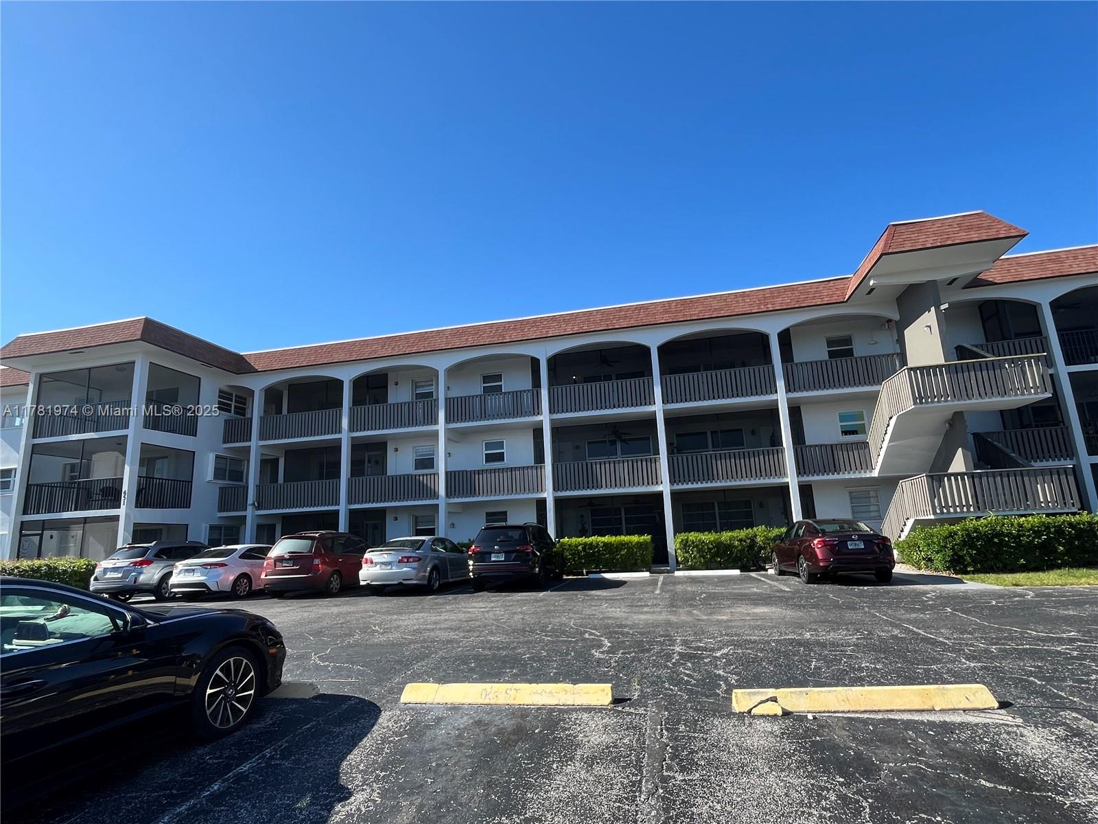 651 Pine Drive, Unit 305 Pompano Beach, FL 33060 - Photo 5 of 21 a front view of a house with a yard
