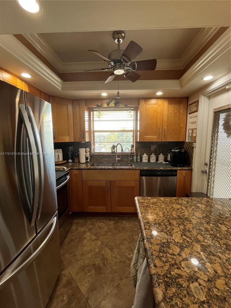 651 Pine Drive, Unit 305 Pompano Beach, FL 33060 - Photo 10 of 21 a kitchen with stainless steel appliances a refrigerator a stove a sink and a microwave