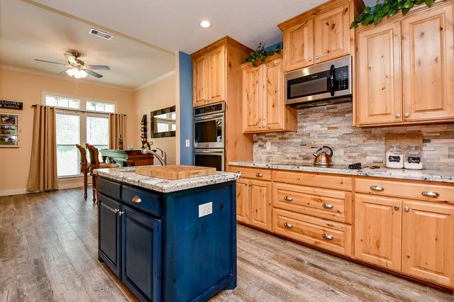 a kitchen with stainless steel appliances granite countertop a stove and a sink