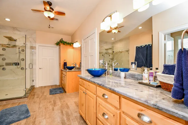 a spacious bathroom with double vanity and a mirror