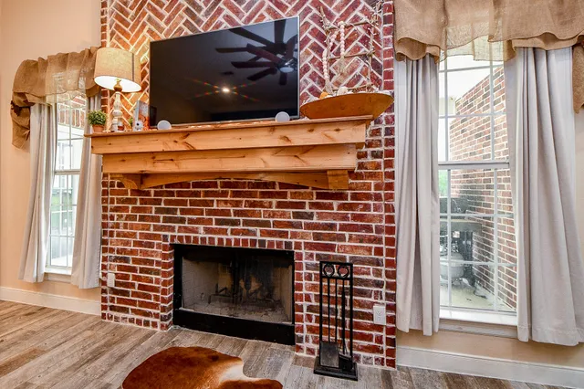 a living room with a fireplace and a wooden floor