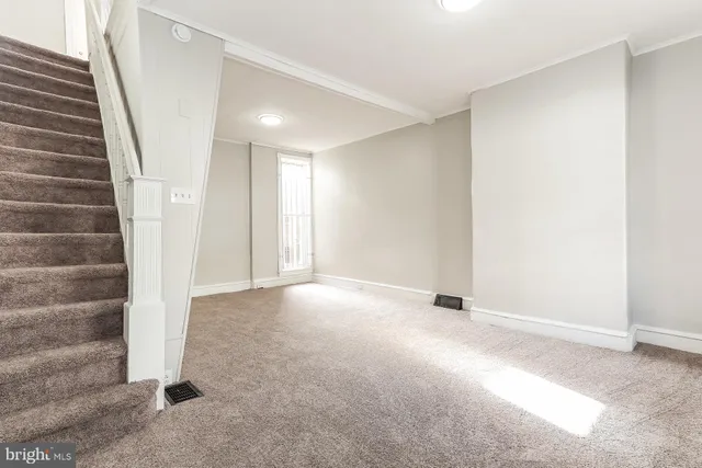 a view of an empty room with stairs