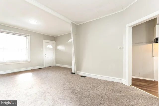 an empty room with windows and closet