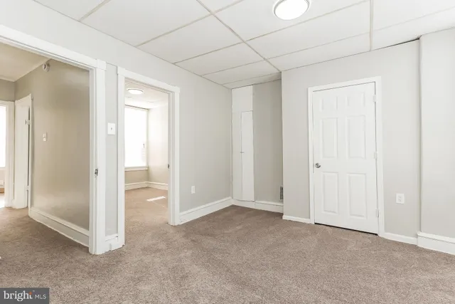 an empty room with windows and closet