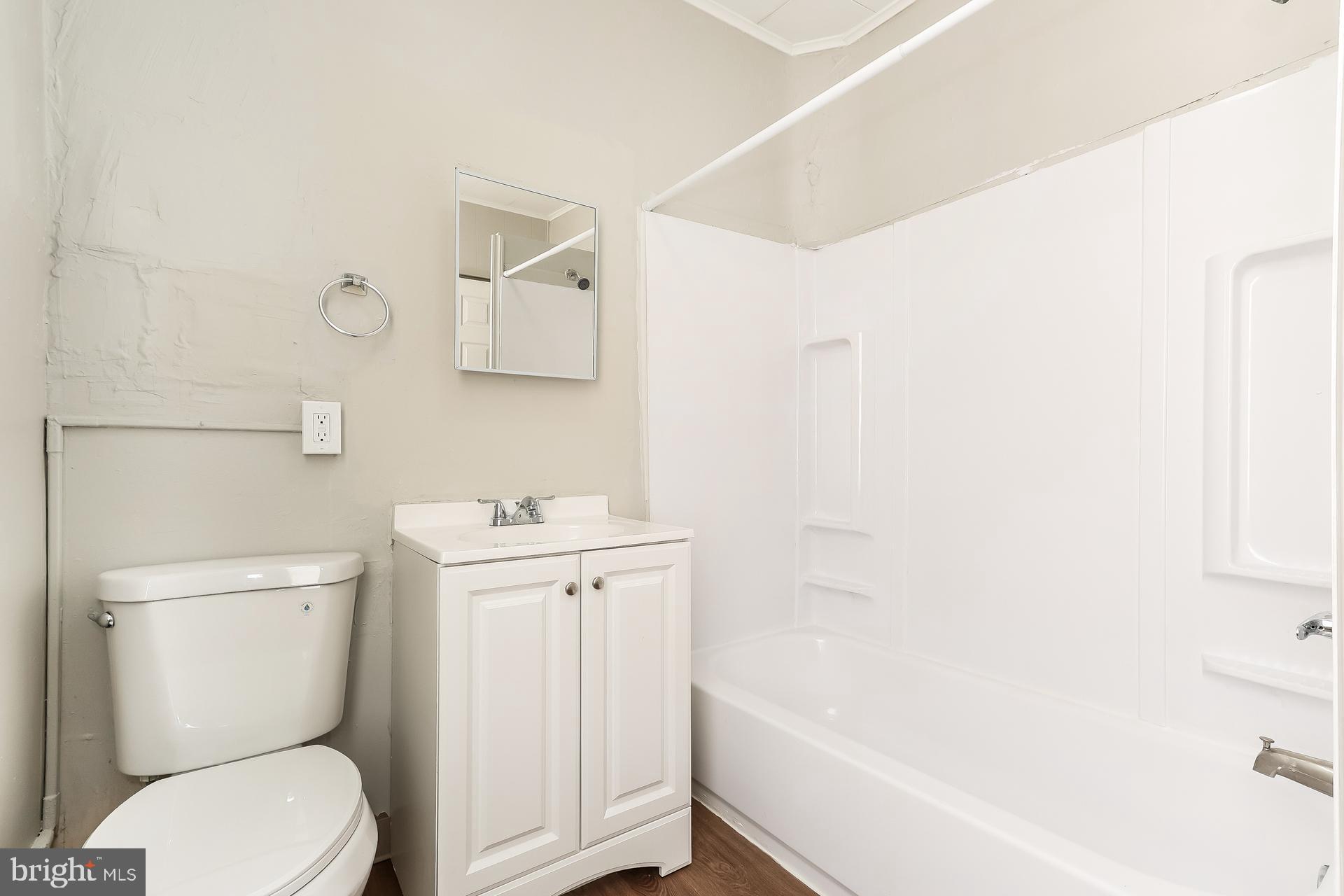 5416 Spring Street Philadelphia, PA 19139 - Photo 9 of 12 a white toilet sitting next to a bath tub