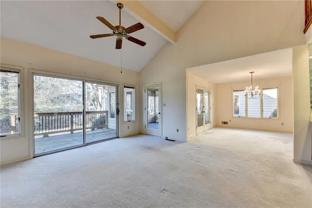 a dining room with furniture a chandelier and wooden floor