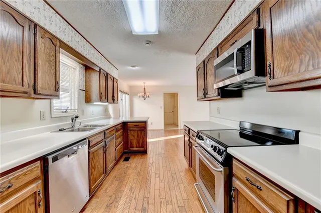 a kitchen with a sink a cabinets and window