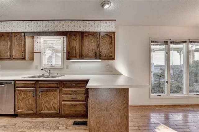 a view of empty room with fireplace and wooden floor