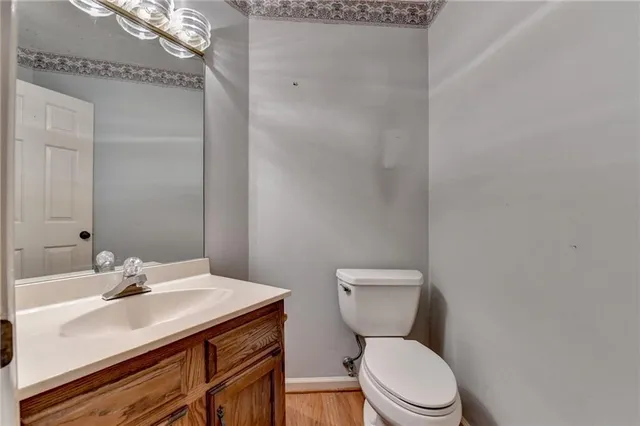 a bathroom with a granite countertop double vanity sink and a mirror