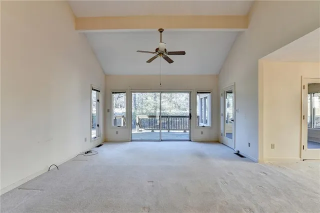 an empty room with chandelier fan