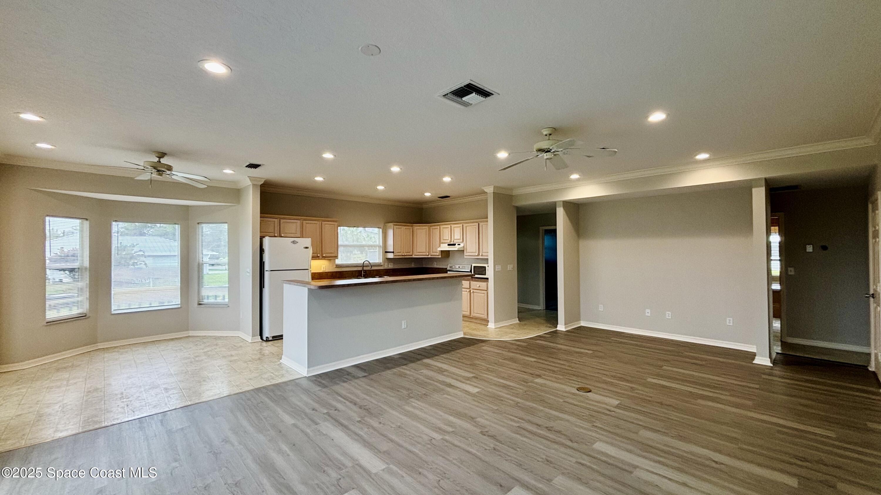 5508 Ambersand Place Grant-Valkaria, FL 32949 - Photo 14 of 30 a view of kitchen with kitchen island granite countertop refrigerator and stove top oven