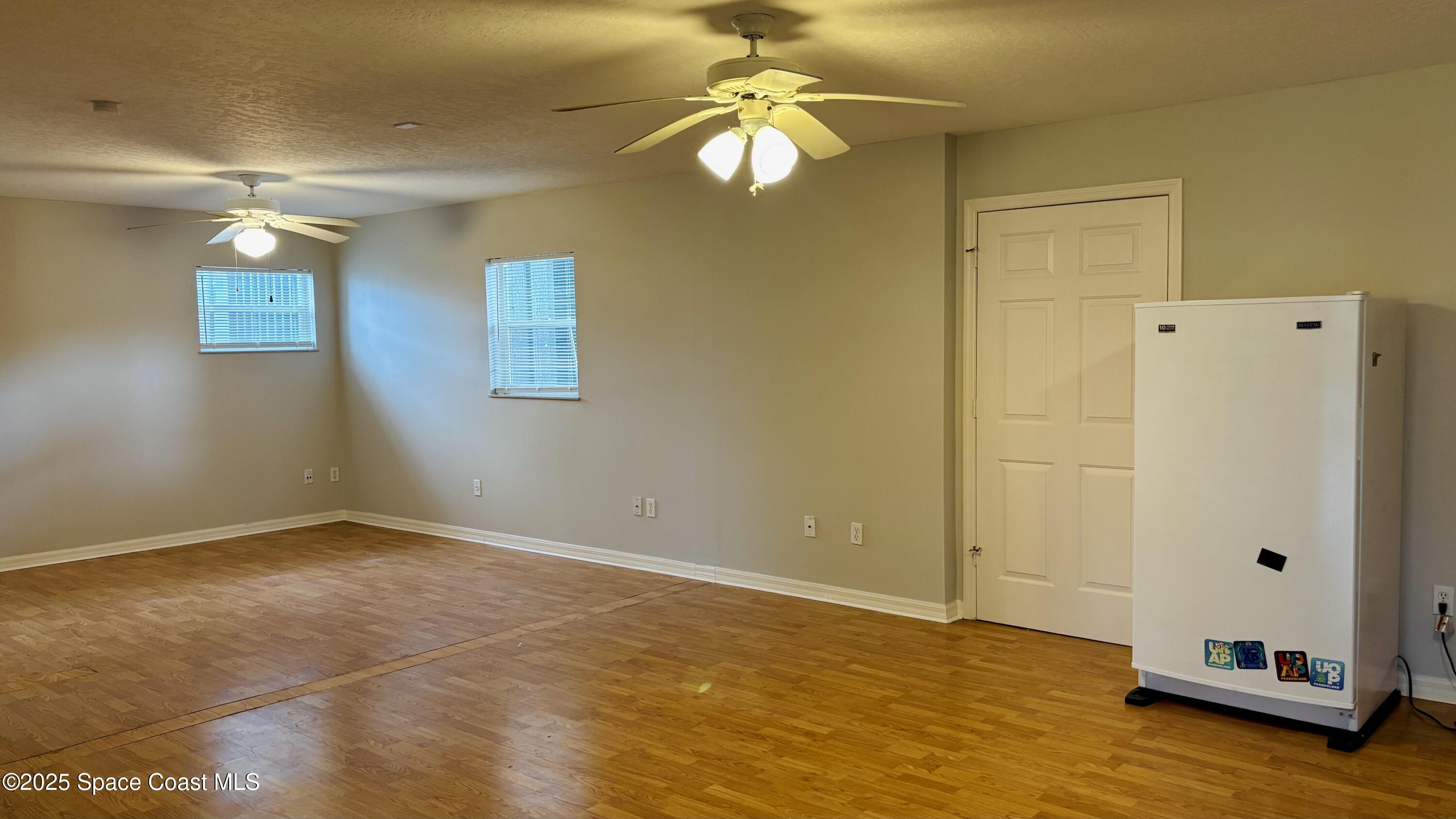 5508 Ambersand Place Grant-Valkaria, FL 32949 - Photo 18 of 30 a view of an empty room with window and wooden floor