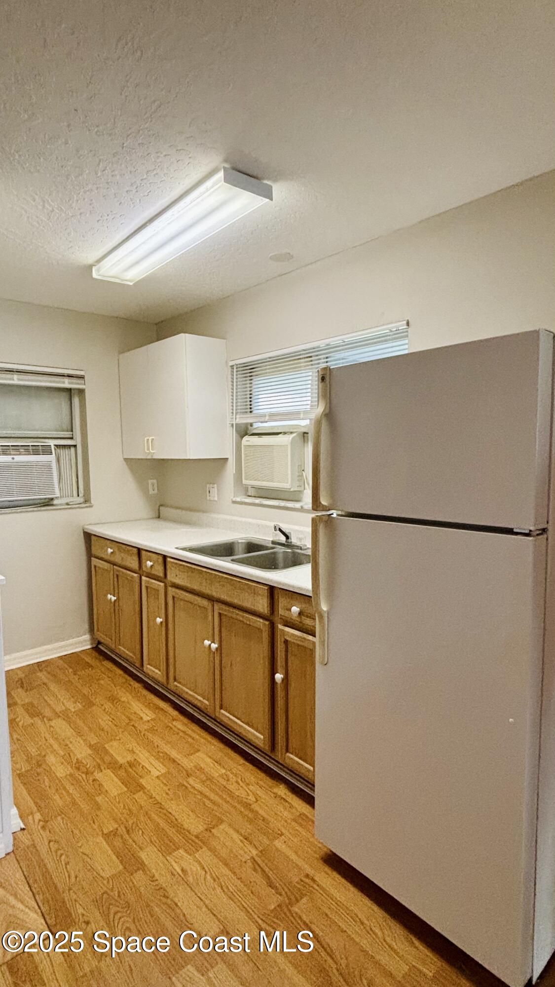 5508 Ambersand Place Grant-Valkaria, FL 32949 - Photo 20 of 30 a kitchen with stainless steel appliances granite countertop a refrigerator a stove a sink and a refrigerator