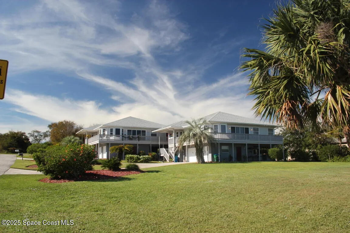 5508 Ambersand Place Grant-Valkaria, FL 32949 - Photo 2 of 30 a front view of a building with garden