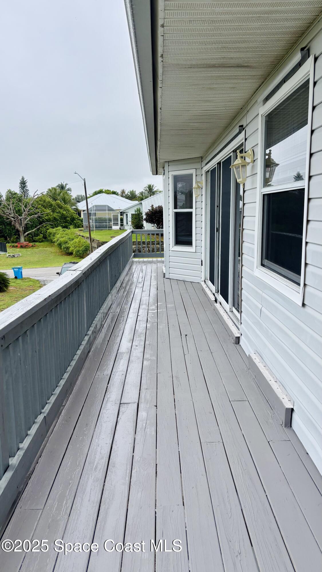 5508 Ambersand Place Grant-Valkaria, FL 32949 - Photo 25 of 30 a view of balcony with wooden floor and outdoor space