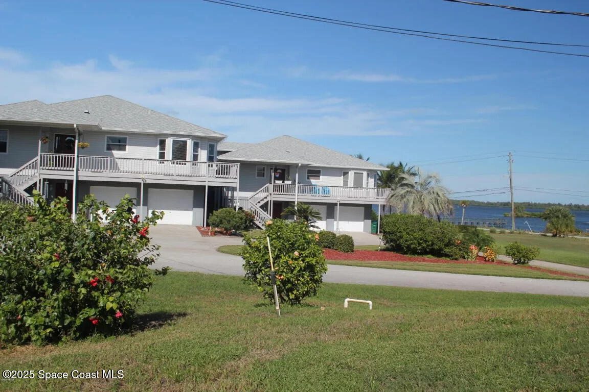 5508 Ambersand Place Grant-Valkaria, FL 32949 - Photo 3 of 30 a front view of a house with a garden