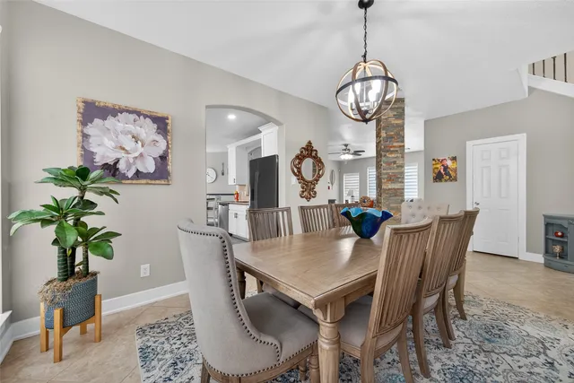a view of a dining room with furniture wooden floor and a chandelier