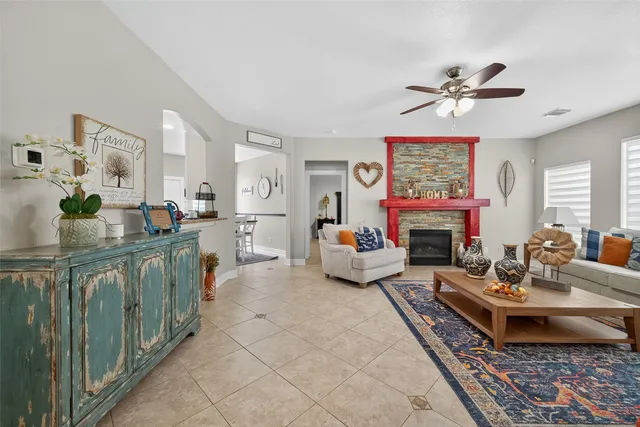 a living room with furniture a fireplace and a table