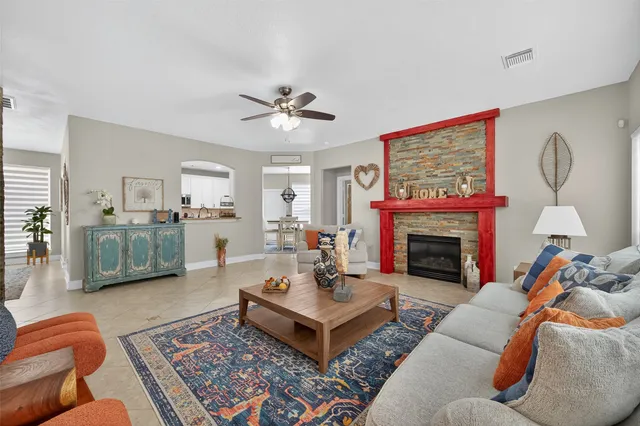 a living room with furniture fireplace and window