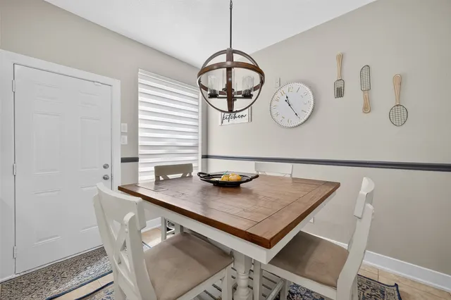a view of dining table chairs and window