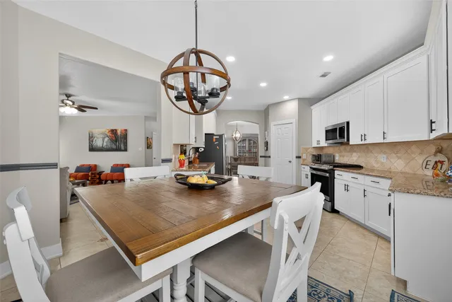 a kitchen with sink cabinets and chandelier