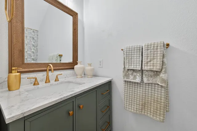a bathroom with a sink vanity and a mirror