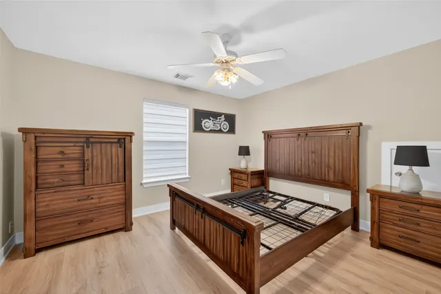 a living room with furniture and a ceiling fan