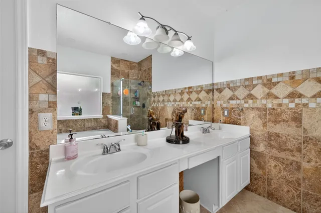 a bathroom with a sink vanity and a mirror